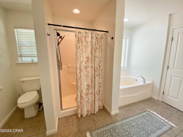 bathroom with tile patterned flooring, toilet, and plus walk in shower