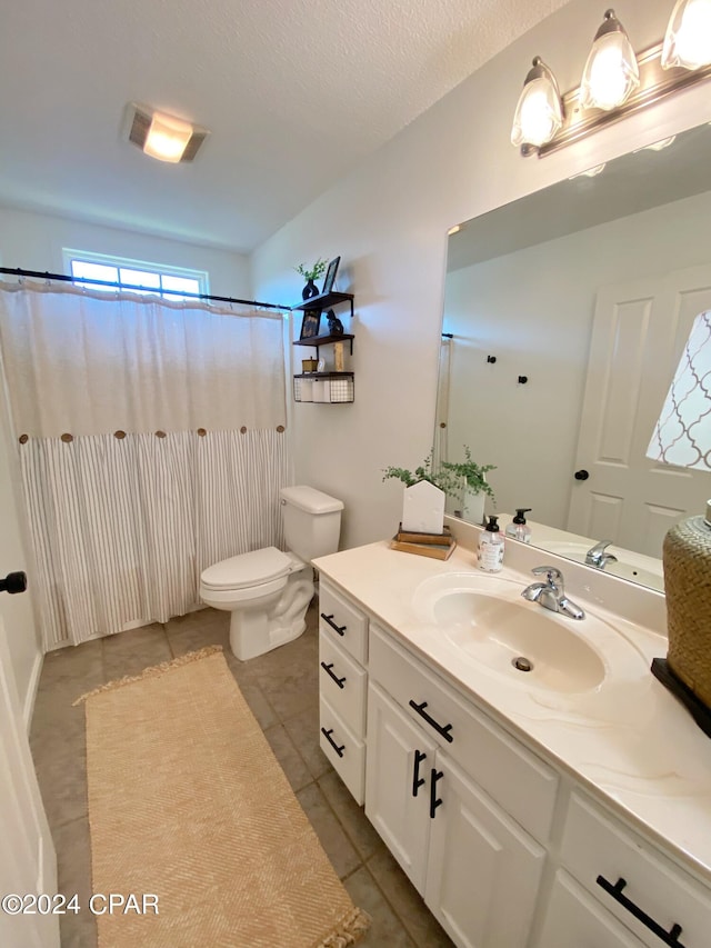 bathroom with curtained shower, tile patterned floors, a textured ceiling, toilet, and vanity