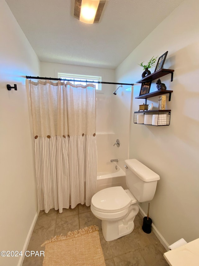 bathroom with tile patterned floors, toilet, and shower / bath combo with shower curtain