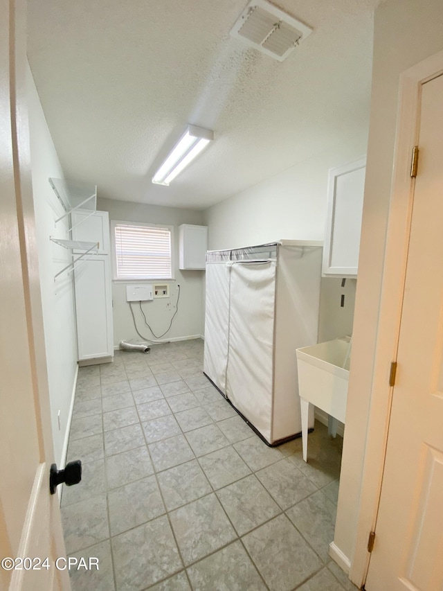 walk in closet with light tile patterned floors