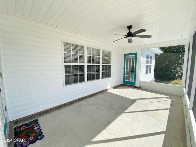 unfurnished sunroom featuring ceiling fan