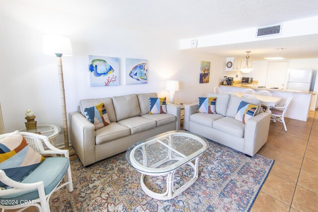 tiled living room with a textured ceiling