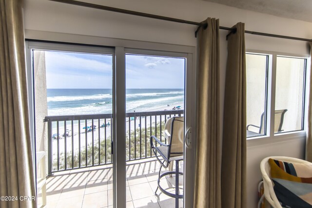 balcony with a beach view and a water view