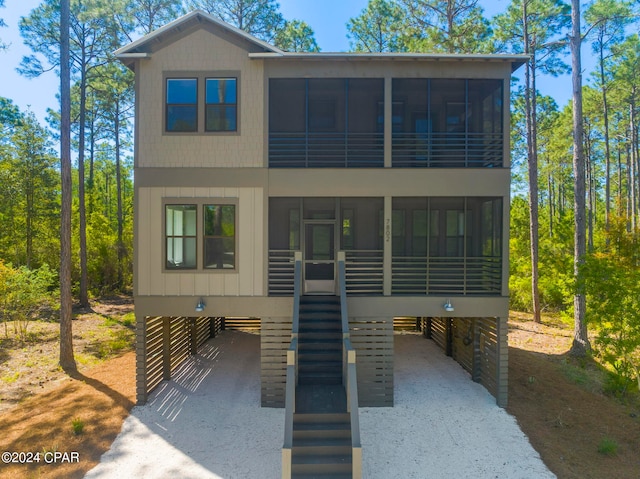 view of front of property featuring a carport and a sunroom