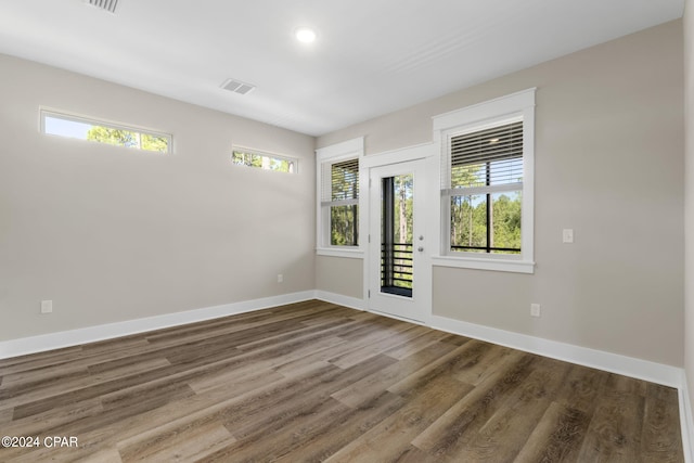 unfurnished room with wood-type flooring