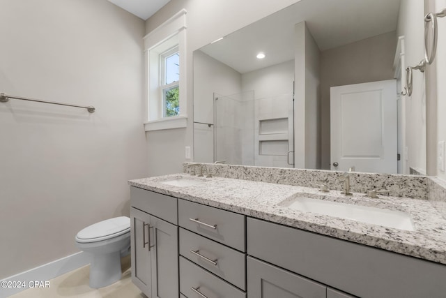 bathroom with double vanity and toilet