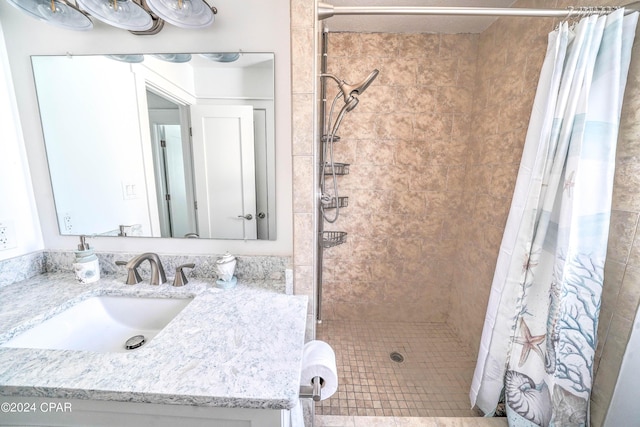 bathroom with curtained shower and vanity