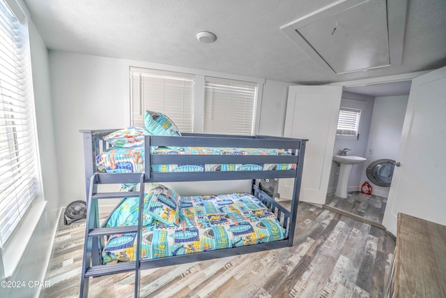 bedroom with a textured ceiling and hardwood / wood-style floors