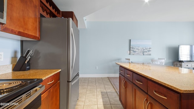 kitchen with light stone counters and light tile patterned flooring