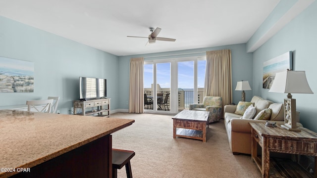 living room featuring ceiling fan and light colored carpet