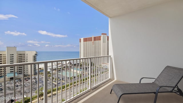 balcony featuring a water view and a view of the beach