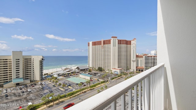 balcony featuring a water view and a view of the beach