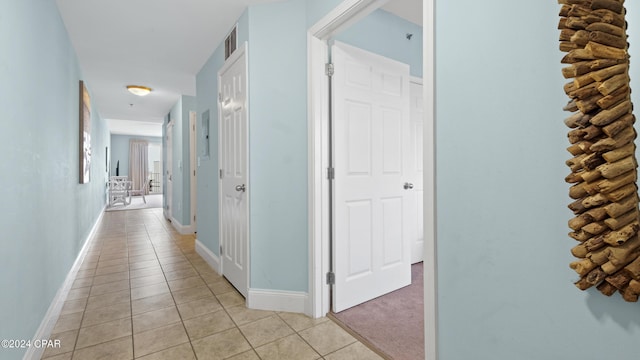 hall featuring light tile patterned floors