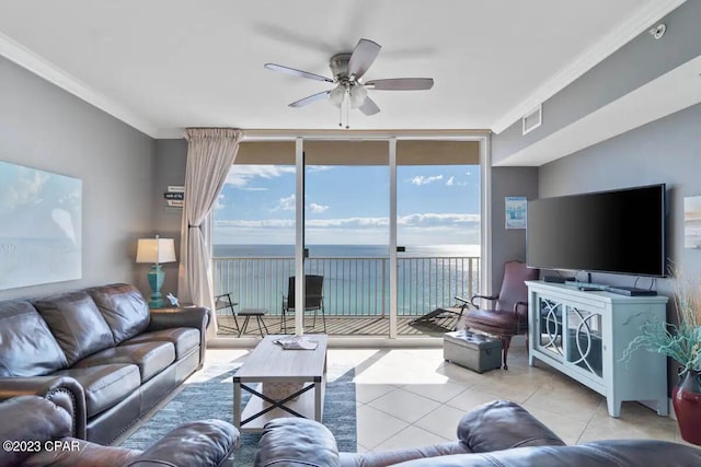 living room featuring ceiling fan, a water view, light tile floors, expansive windows, and crown molding