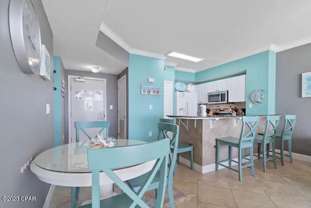 tiled dining room with crown molding