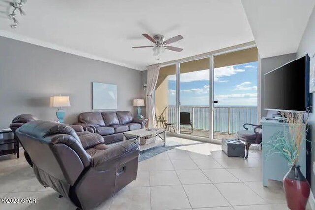 tiled living room featuring crown molding, ceiling fan, track lighting, and expansive windows