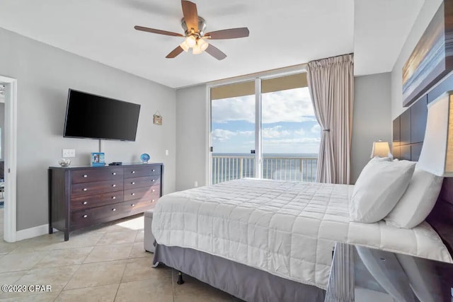 bedroom with access to exterior, ceiling fan, expansive windows, and light tile floors