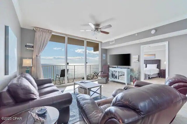 living room with floor to ceiling windows and ceiling fan