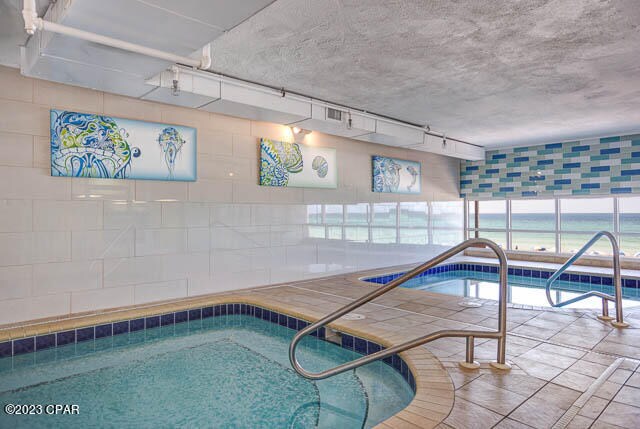 view of pool with an indoor hot tub