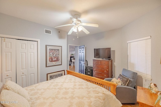 bedroom with a closet, wood-type flooring, and ceiling fan