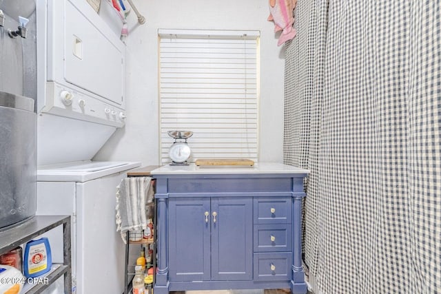 bathroom featuring vanity and stacked washer and dryer