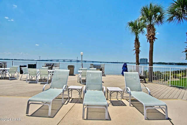 view of patio with a deck with water view