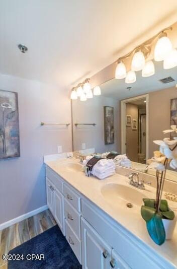 bathroom featuring hardwood / wood-style floors and dual bowl vanity