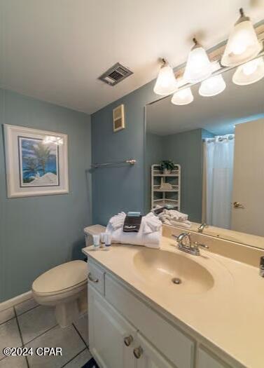 bathroom with vanity, toilet, and tile floors