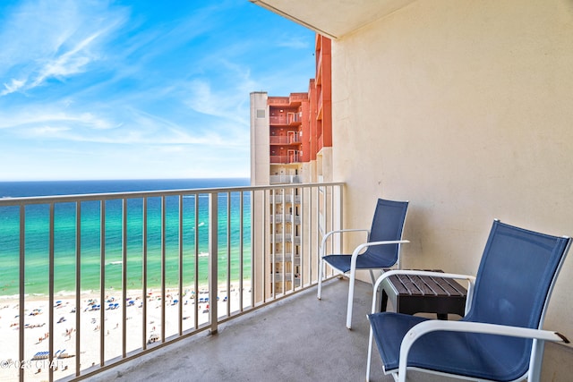 balcony featuring a beach view and a water view