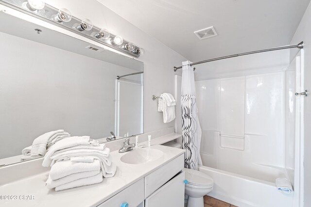 full bathroom with shower / bath combination with curtain, tile patterned flooring, vanity, and toilet