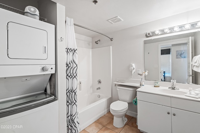 full bathroom featuring shower / tub combo, stacked washing maching and dryer, vanity, toilet, and tile patterned floors