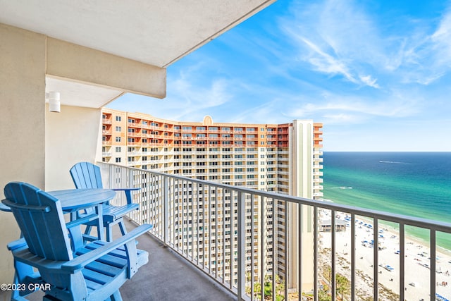 balcony featuring a water view and a beach view