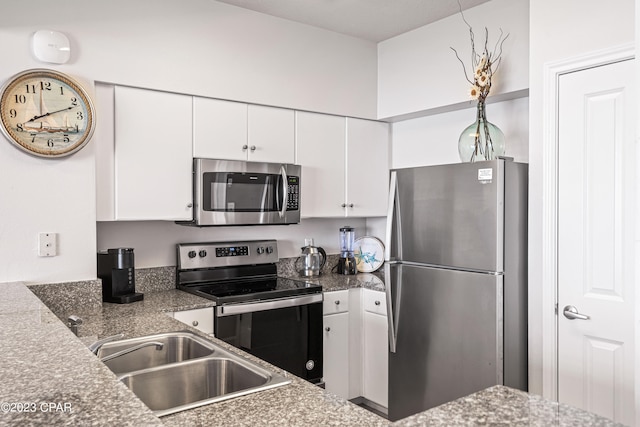 kitchen featuring white cabinets, stainless steel appliances, and sink