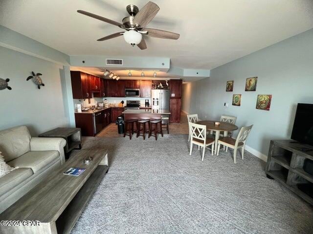 carpeted living room featuring ceiling fan