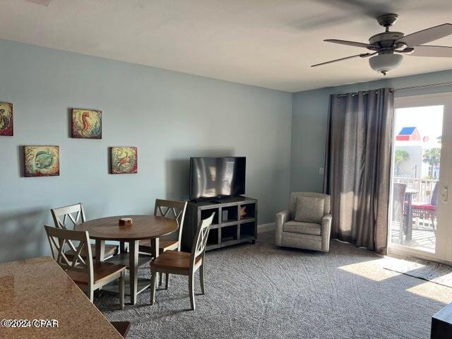 dining area with ceiling fan and carpet flooring