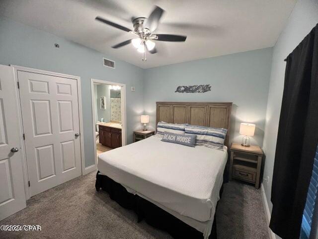 bedroom featuring carpet flooring, ensuite bath, and ceiling fan