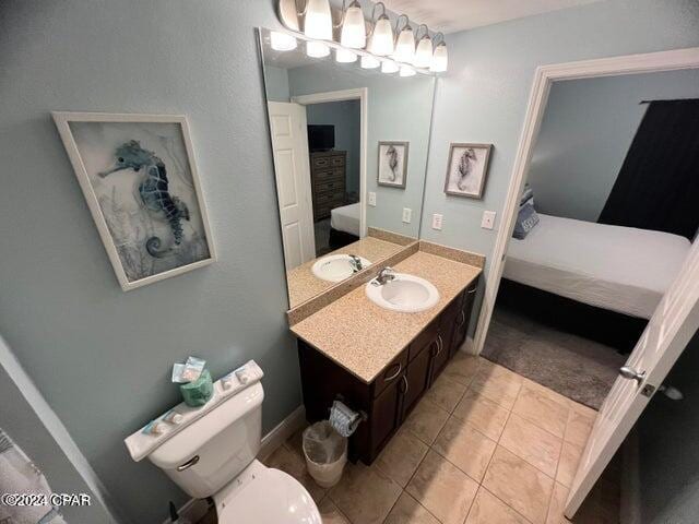 bathroom featuring oversized vanity, tile floors, and toilet