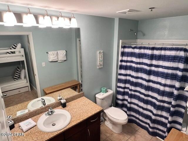 bathroom featuring vanity, toilet, and tile floors