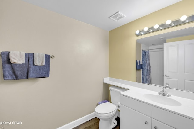 bathroom with vanity, hardwood / wood-style floors, a shower with curtain, and toilet