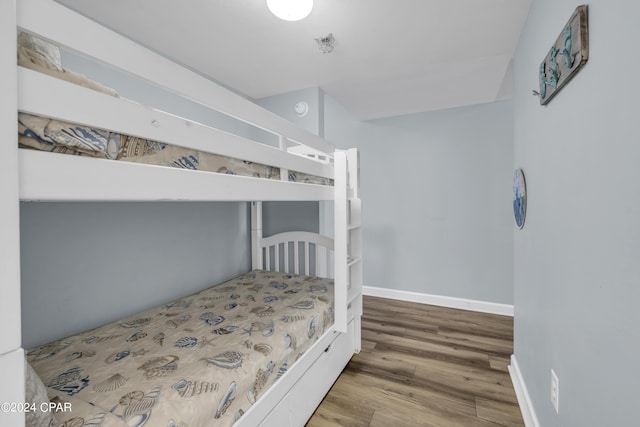 bedroom with hardwood / wood-style flooring