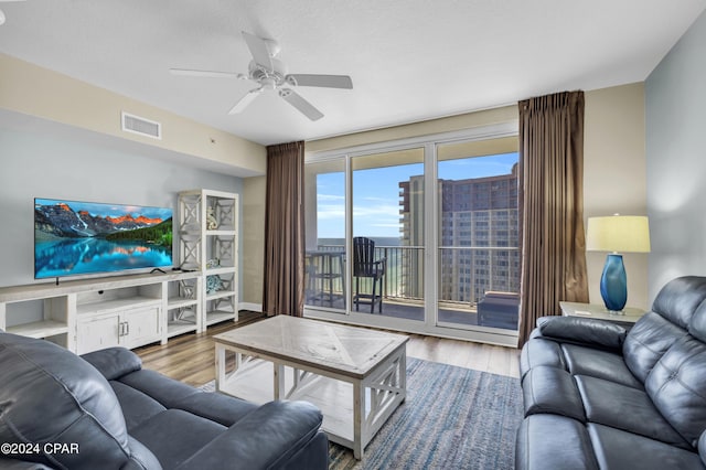 living room featuring ceiling fan and wood-type flooring