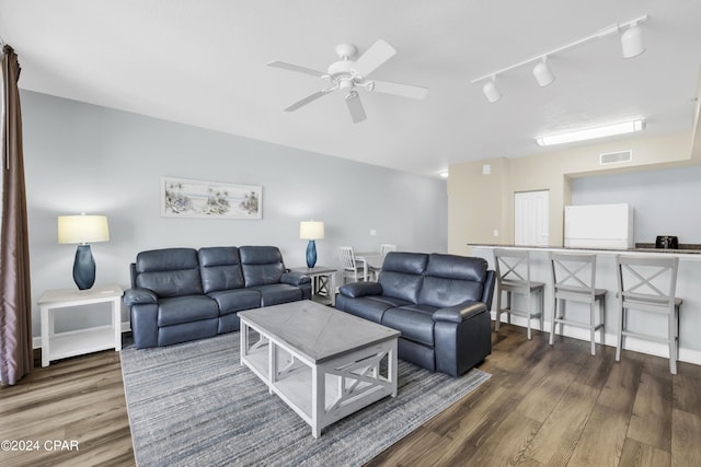 living room featuring dark hardwood / wood-style floors and ceiling fan