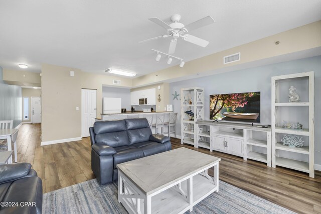 living room with hardwood / wood-style floors and ceiling fan