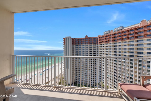 balcony featuring a water view and a beach view