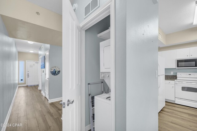 interior space featuring light hardwood / wood-style flooring and stacked washer and clothes dryer