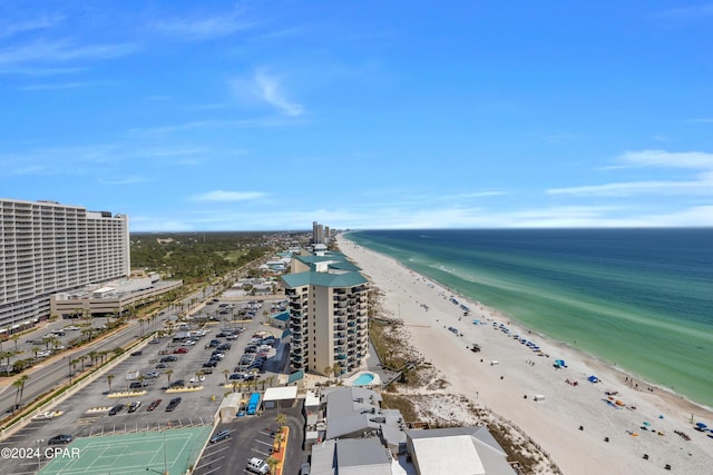 birds eye view of property with a water view and a beach view