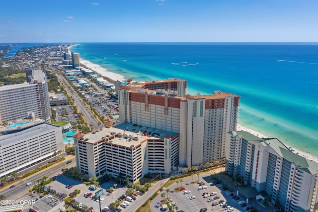 drone / aerial view featuring a water view and a beach view