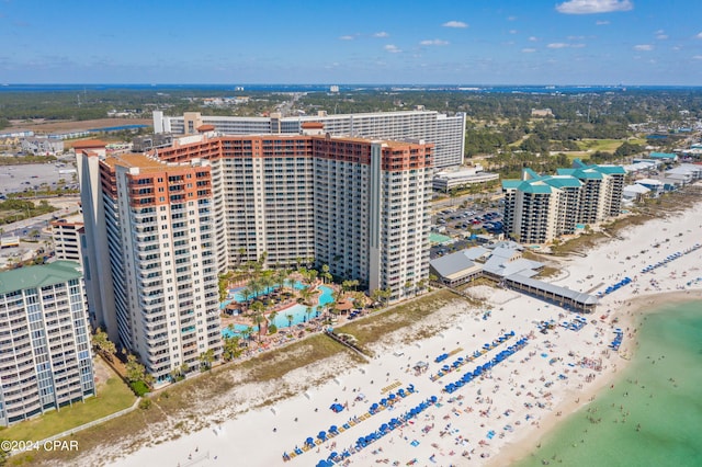 drone / aerial view featuring a water view and a beach view