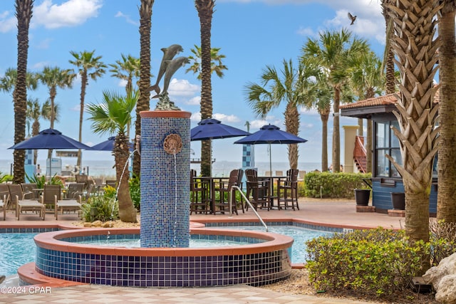 exterior space with pool water feature and a patio area