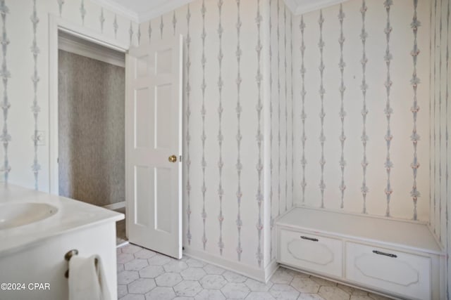 bathroom featuring crown molding, tile flooring, and vanity